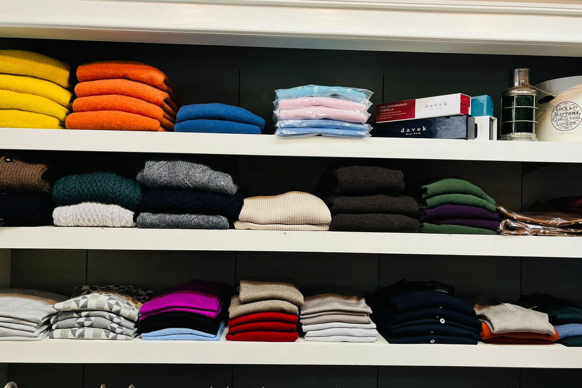 Knitwear and shirts arranged on the shelves at Wm. Fox