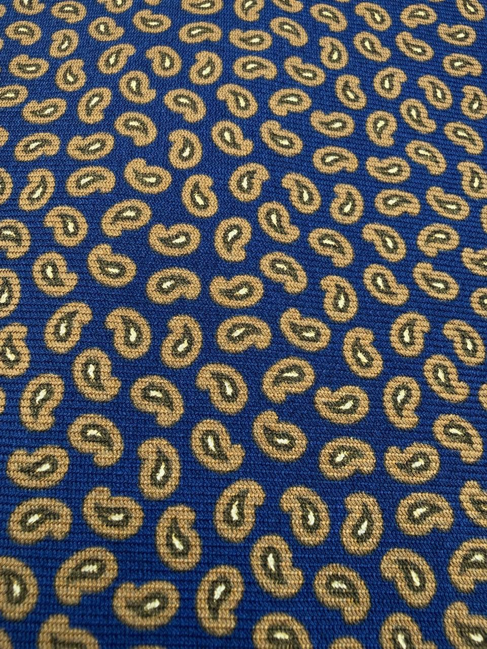 Close-up of navy and gold paisley necktie fabric